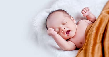 L'Effondrement Démographique en France Un Appel à la Sortie de l'Union Européenne - baby lying on white fur with brown blanket